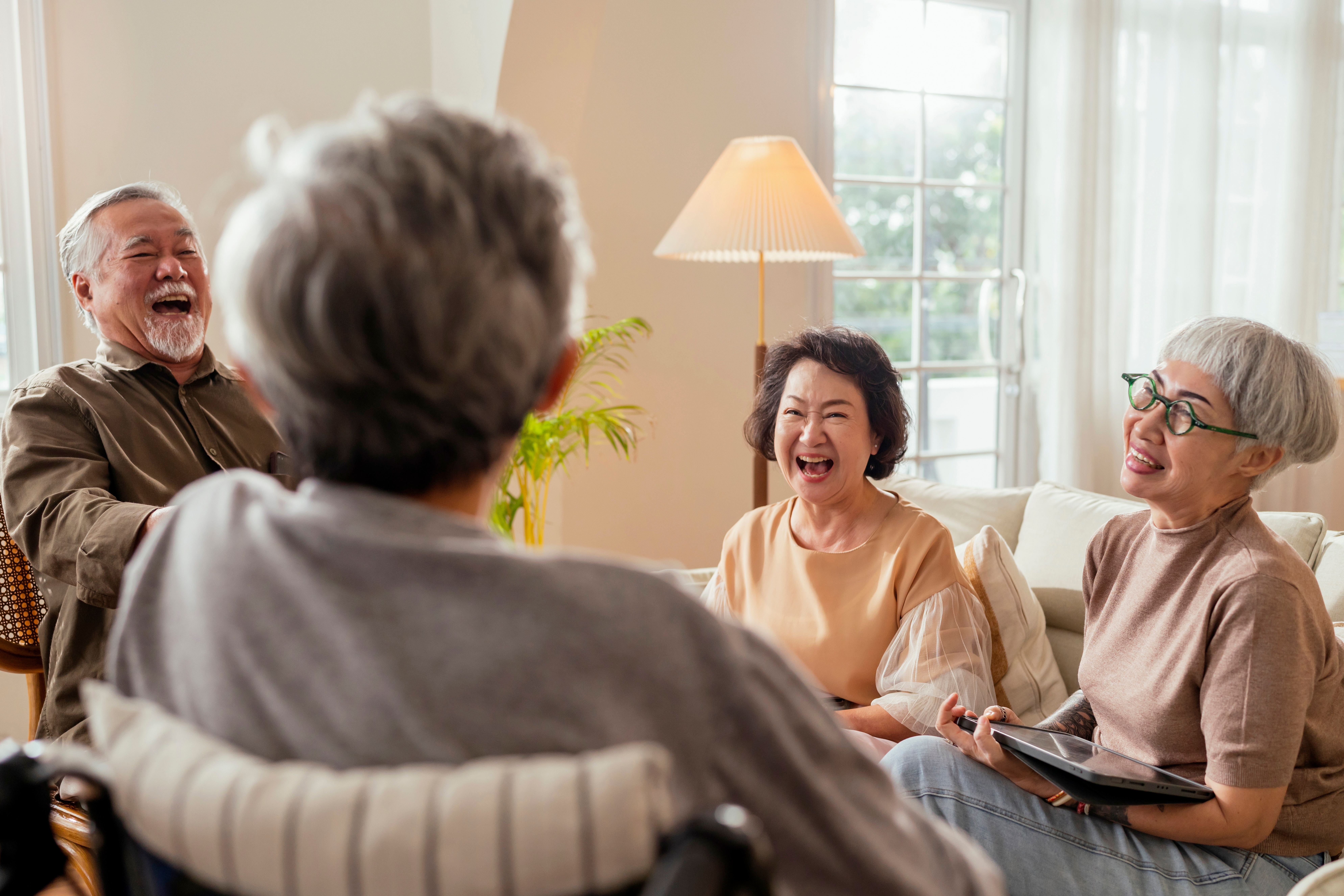 old retired friends gathering and laughing together
