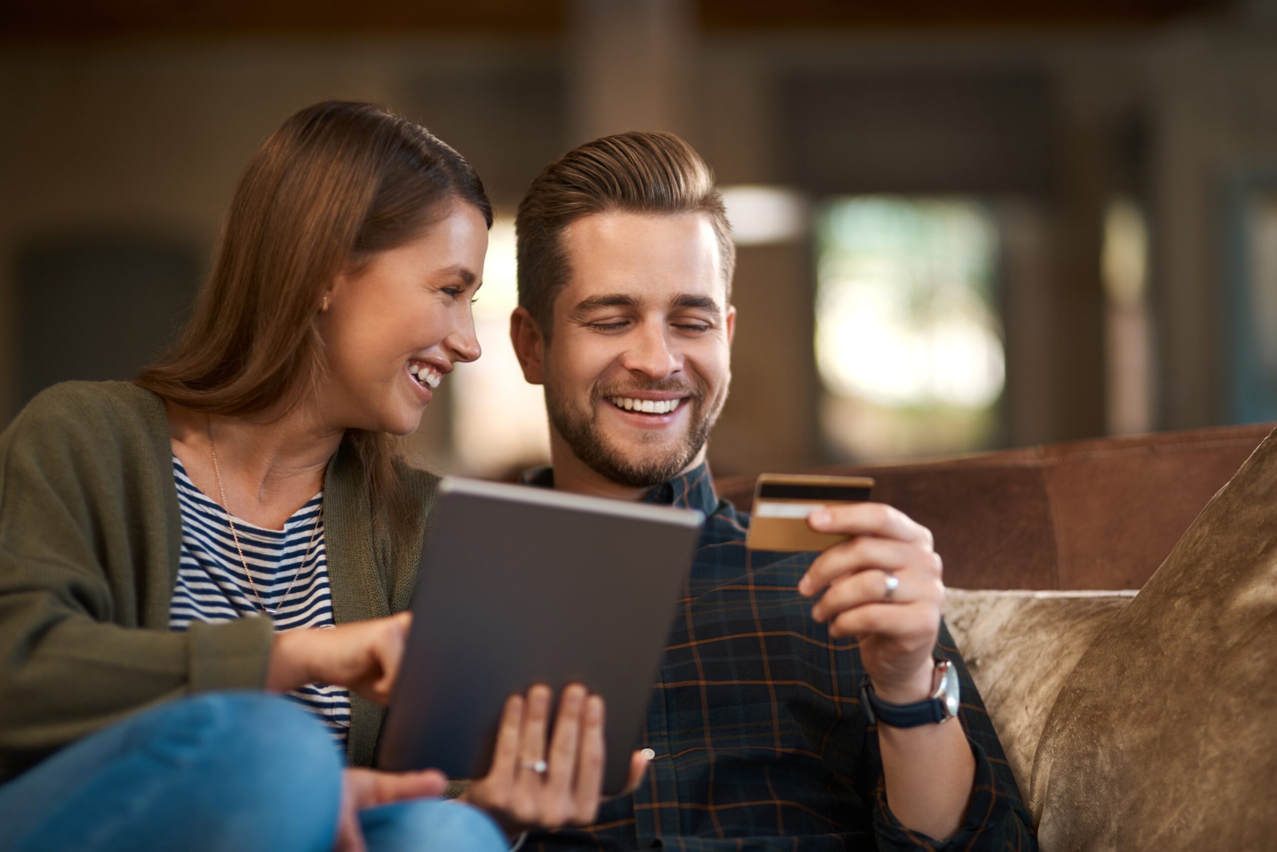 bank card and a couple holding tablet